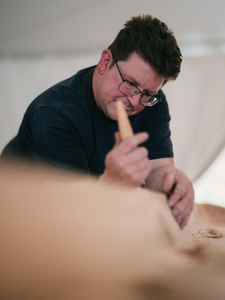 Beau Wagner carving red cedar with a curved knife