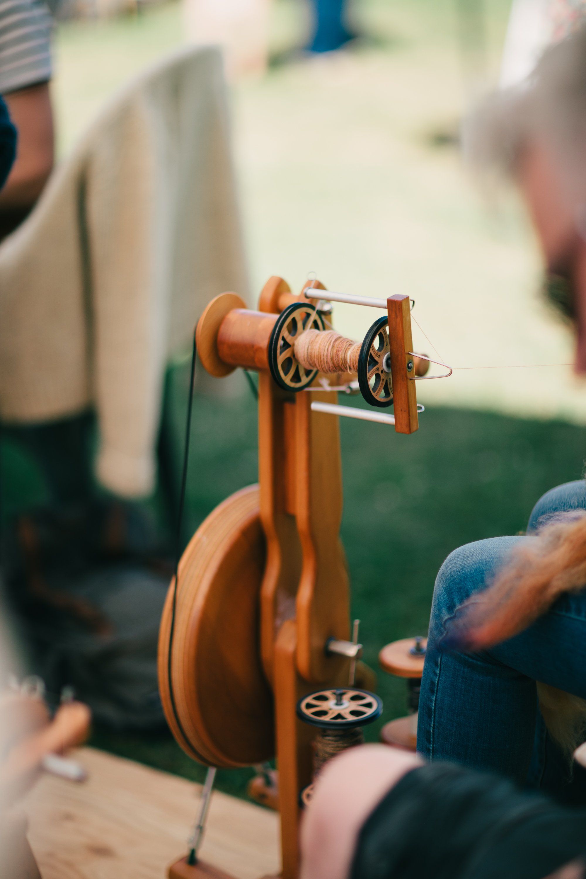 Wooden pulley system with orange frame at Ruckle Farm, hands adjusting rope in soft natural daylight