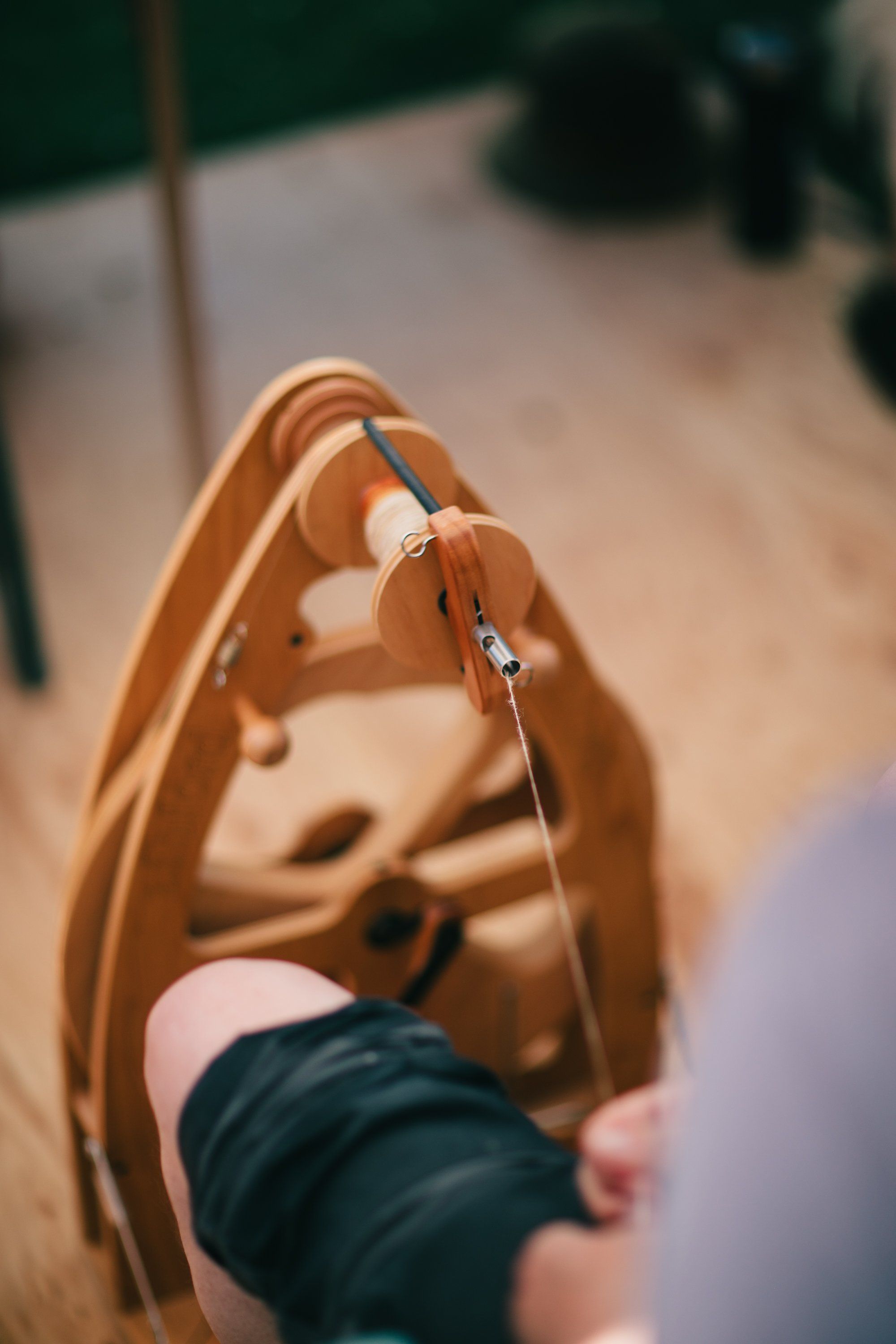 Tan leather bag held open in sunlit hands, revealing a delicate ring inside, with blurred farm setting behind