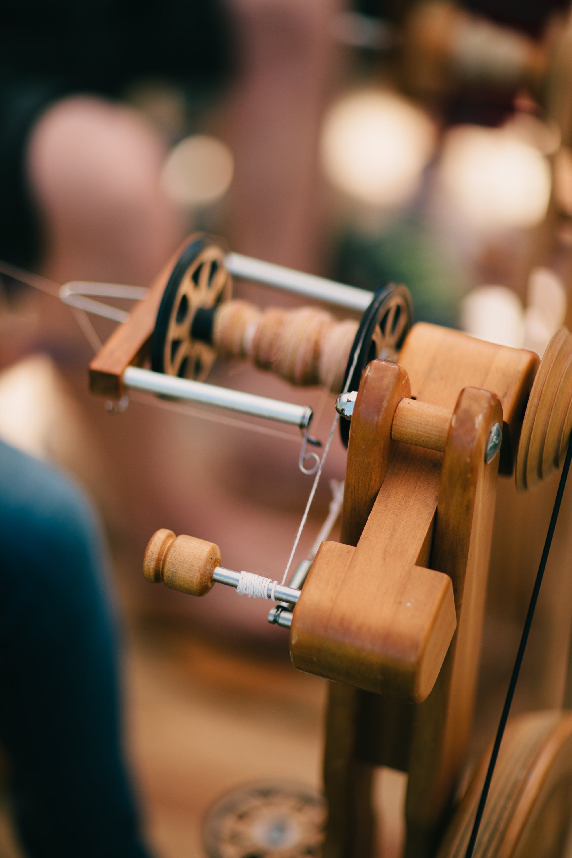 Wooden spinning wheels with brass accents and thread spools catch warm, golden sunlight at Ruckle Farm