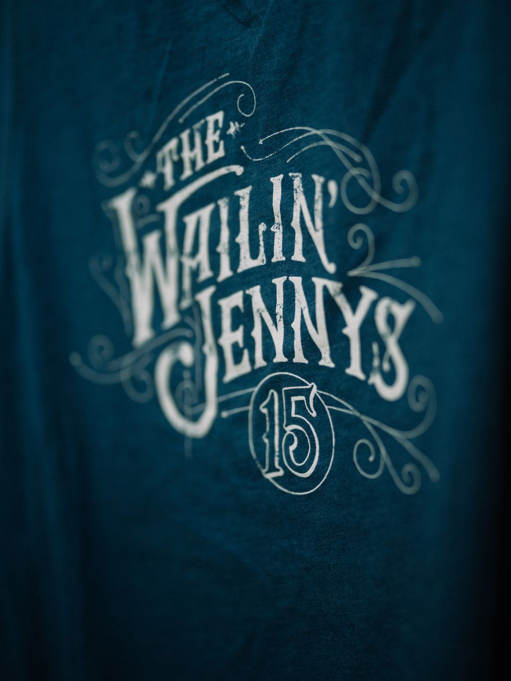 Ornate white typography reading "The Wailin' Jenny" with decorative scrollwork and the number 15 on deep teal background